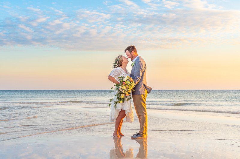 Bride & Groom kissing at the shore for a photo in Gulf Shores.