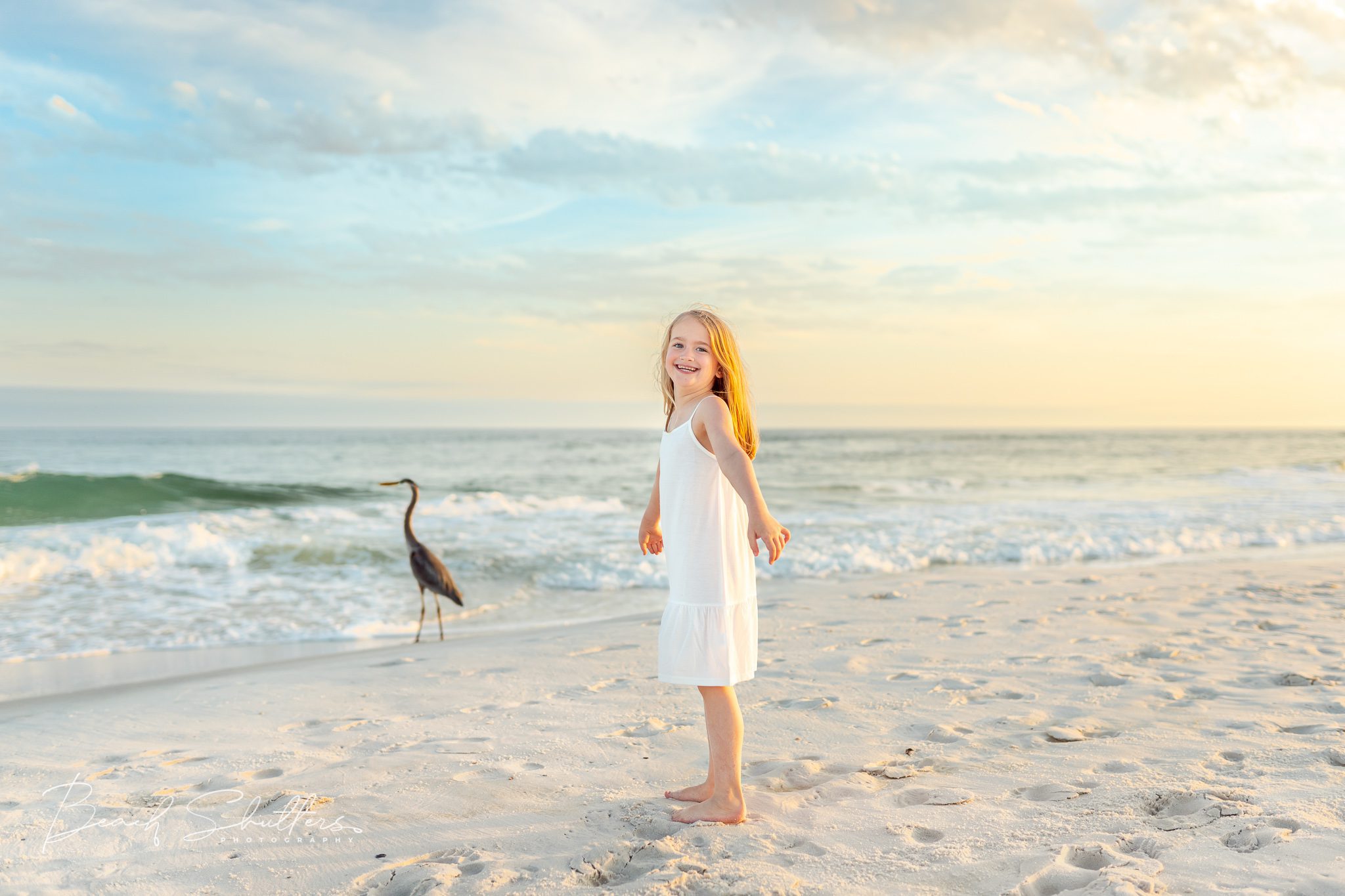 Family photographer girl with a blue herron.